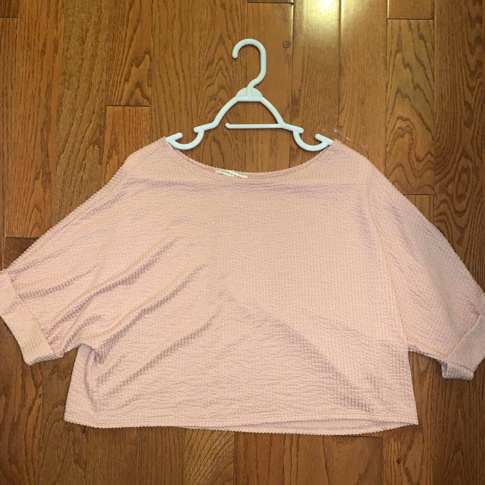 This is a light pink flowy crop top with cuffed sleeves and swoop neck line (L)